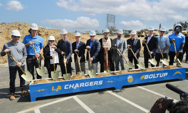 Chargers Groundbreaking people with shovels in box with dirt